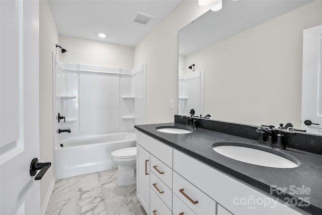 full bathroom featuring toilet, vanity, and tub / shower combination