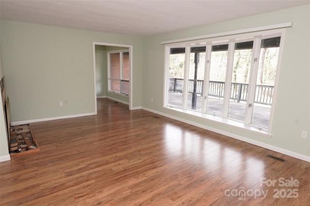 unfurnished living room with dark hardwood / wood-style flooring