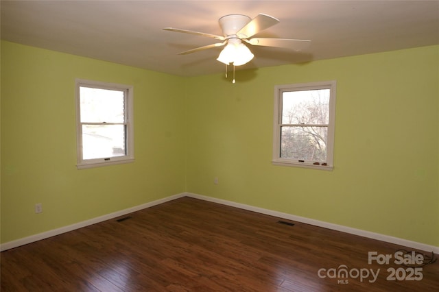 unfurnished room with ceiling fan and dark hardwood / wood-style floors