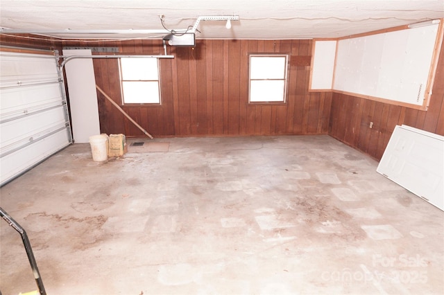 garage featuring wood walls