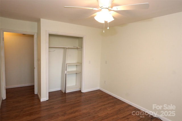 unfurnished bedroom with a closet, baseboards, a ceiling fan, and dark wood finished floors