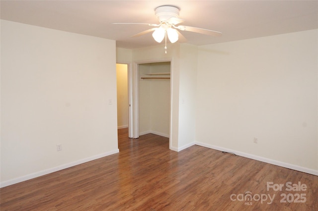unfurnished bedroom with a closet, baseboards, ceiling fan, and wood finished floors