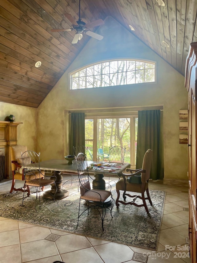 tiled dining area featuring ceiling fan, high vaulted ceiling, and wood ceiling