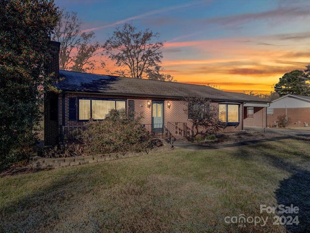 ranch-style house with a yard