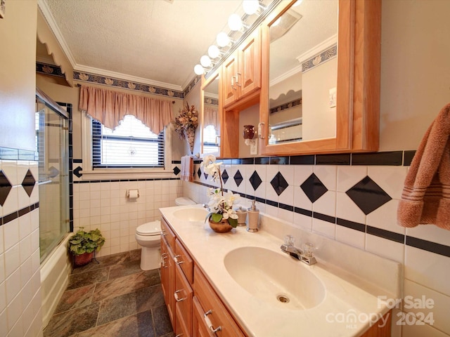 full bathroom featuring toilet, tile walls, ornamental molding, and bath / shower combo with glass door