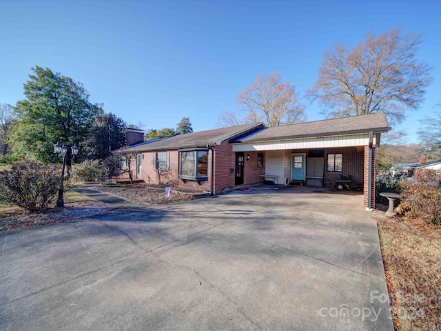 ranch-style house featuring a carport