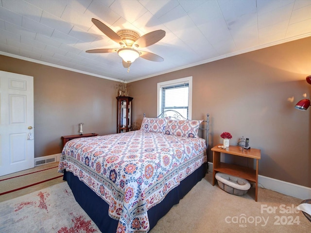 bedroom with carpet, ceiling fan, and ornamental molding