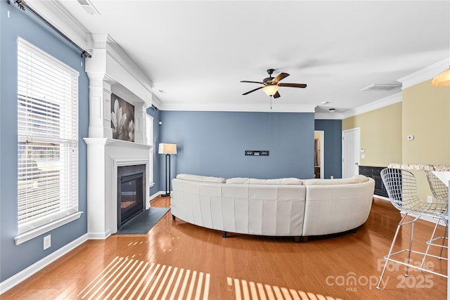 living room with crown molding, ceiling fan, and hardwood / wood-style flooring