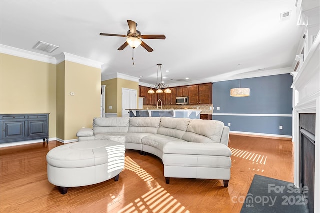 living room with ceiling fan, dark hardwood / wood-style flooring, and ornamental molding