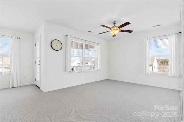 empty room featuring ceiling fan and light carpet