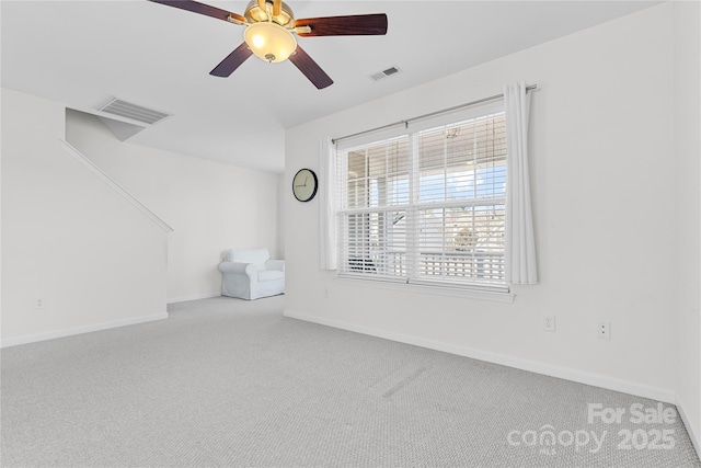 carpeted spare room featuring ceiling fan