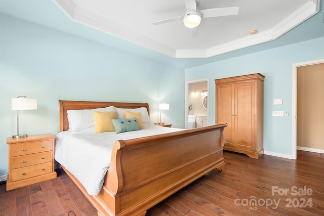 bedroom with a raised ceiling, crown molding, ensuite bath, ceiling fan, and dark hardwood / wood-style flooring