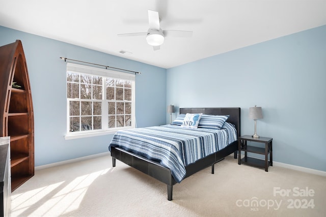 bedroom with light colored carpet and ceiling fan