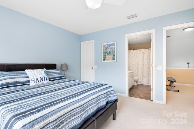 bedroom featuring ensuite bathroom, ceiling fan, and light colored carpet