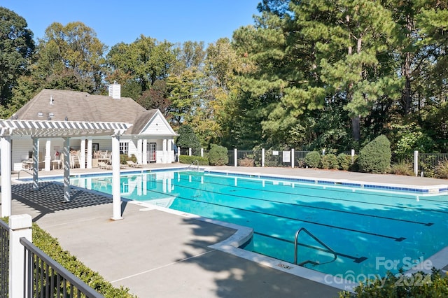 view of pool with a pergola and a patio