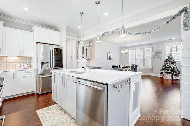 kitchen with white cabinetry, an island with sink, appliances with stainless steel finishes, and dark wood-type flooring