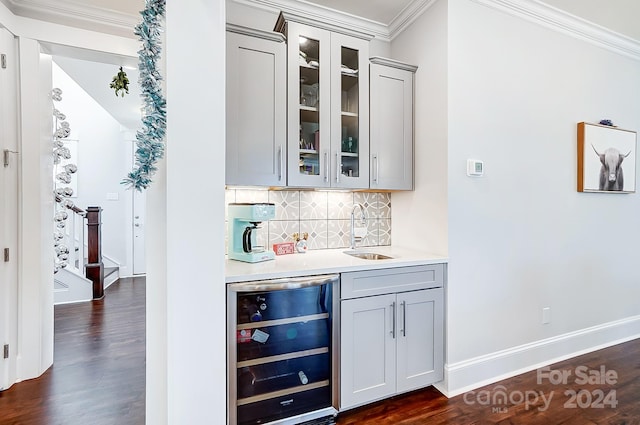 bar with sink, wine cooler, dark hardwood / wood-style flooring, crown molding, and gray cabinets