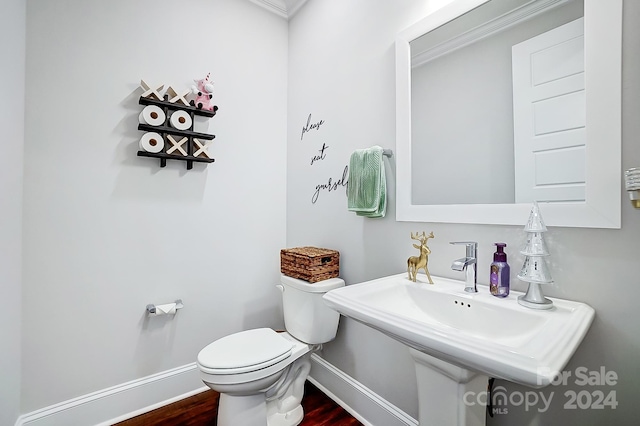 bathroom with hardwood / wood-style floors, toilet, and sink