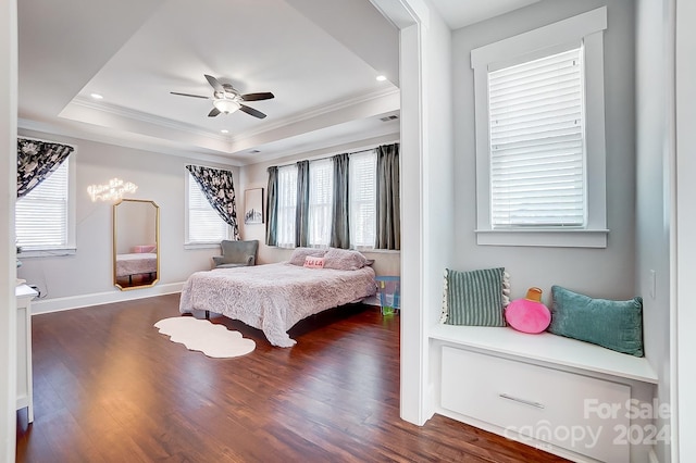 bedroom with a tray ceiling, ceiling fan, crown molding, and dark hardwood / wood-style floors