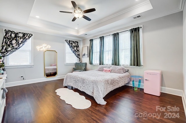 bedroom featuring dark hardwood / wood-style floors, ceiling fan, a raised ceiling, and crown molding