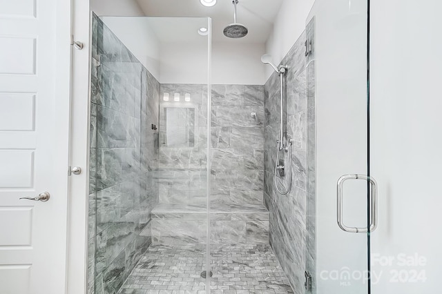 bathroom with a shower with shower door