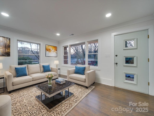 living room with hardwood / wood-style floors and ornamental molding