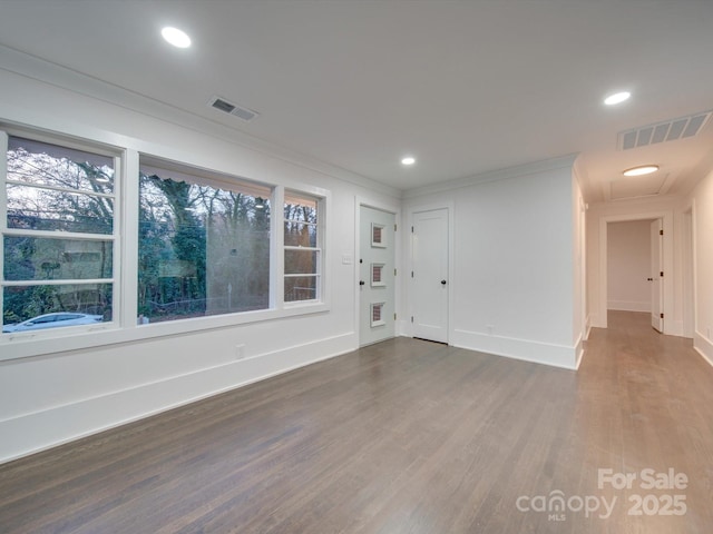 unfurnished room featuring hardwood / wood-style floors and crown molding