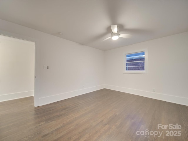 unfurnished room with ceiling fan and dark wood-type flooring