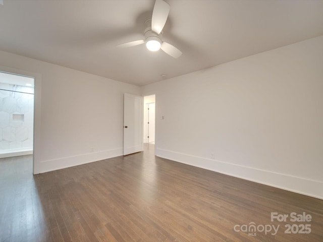 empty room with ceiling fan and dark hardwood / wood-style floors