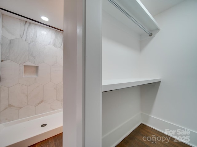 bathroom featuring a shower and hardwood / wood-style floors