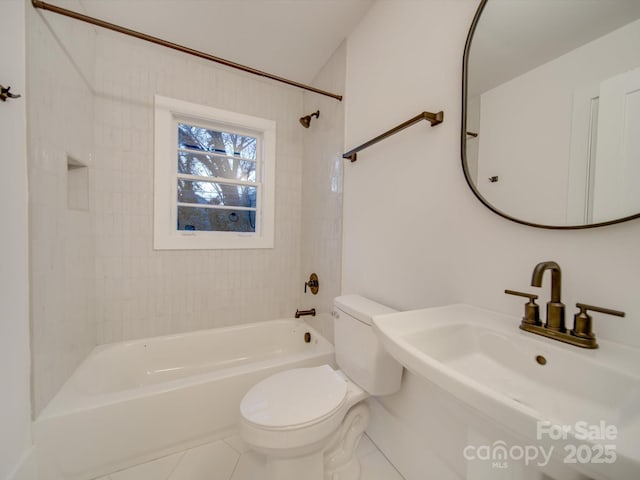 full bathroom with toilet, tile patterned floors, tiled shower / bath, and sink