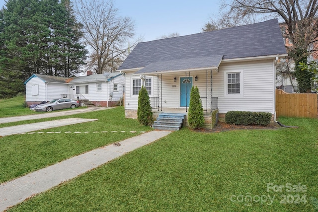 bungalow featuring a front lawn and covered porch