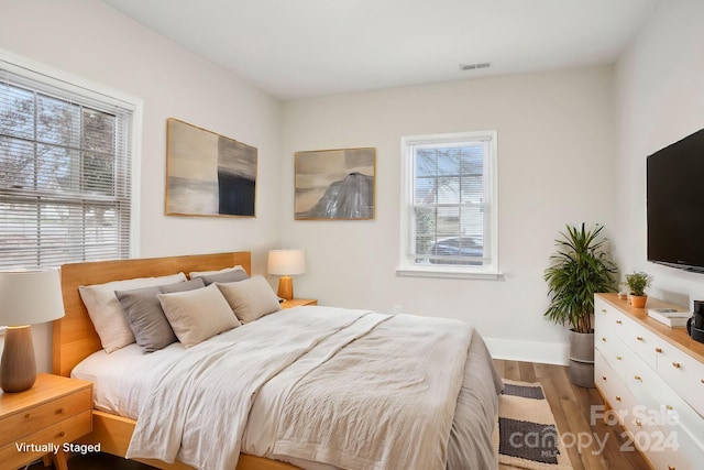 bedroom with wood-type flooring