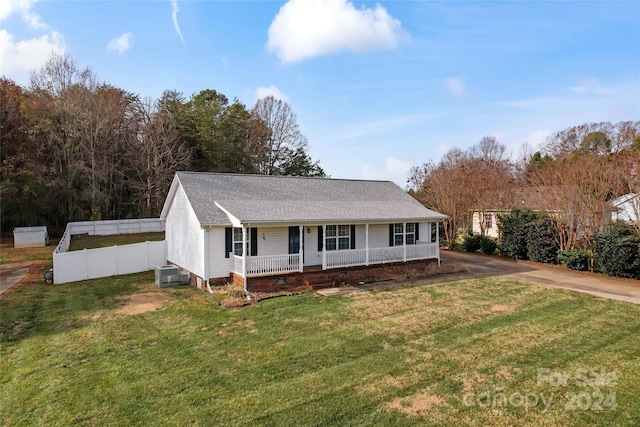 view of front of house with a porch, a front lawn, and central air condition unit