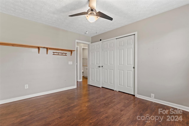 unfurnished bedroom featuring a textured ceiling, ceiling fan, a closet, and dark hardwood / wood-style floors