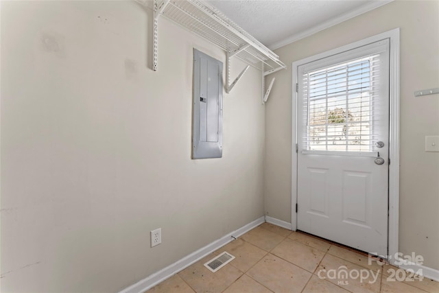 doorway featuring electric panel, ornamental molding, and light tile patterned flooring