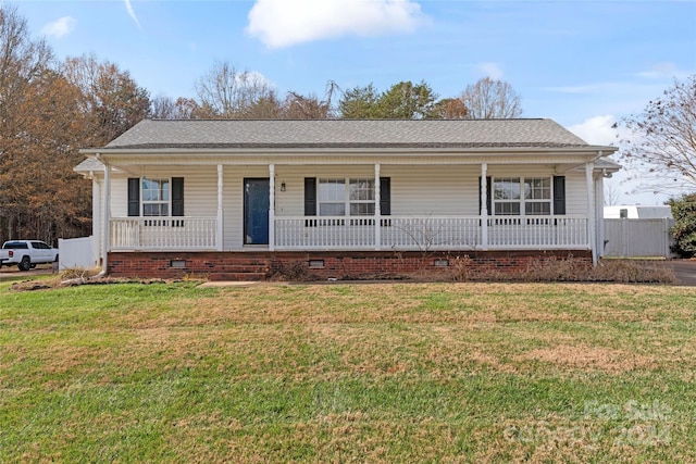 ranch-style home with a front yard and a porch