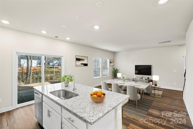 kitchen featuring white cabinets, dark hardwood / wood-style flooring, a center island with sink, and sink