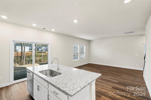 kitchen featuring white cabinets, dark hardwood / wood-style floors, sink, and a kitchen island with sink