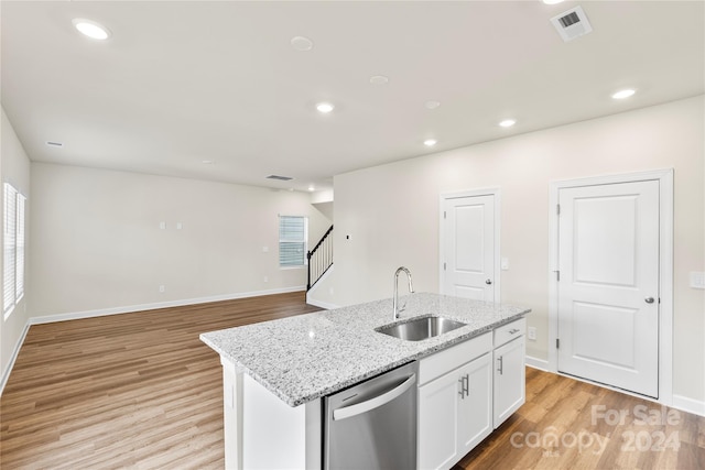 kitchen featuring white cabinets, a center island with sink, sink, stainless steel dishwasher, and light wood-type flooring