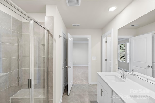 bathroom featuring tile patterned floors, vanity, and a shower with shower door