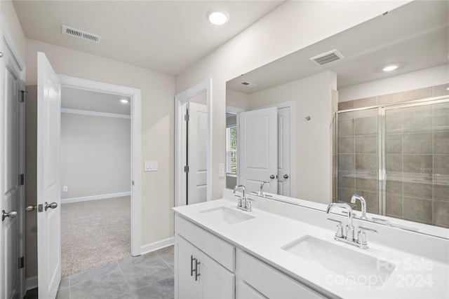 bathroom with tile patterned flooring, vanity, and a shower with shower door