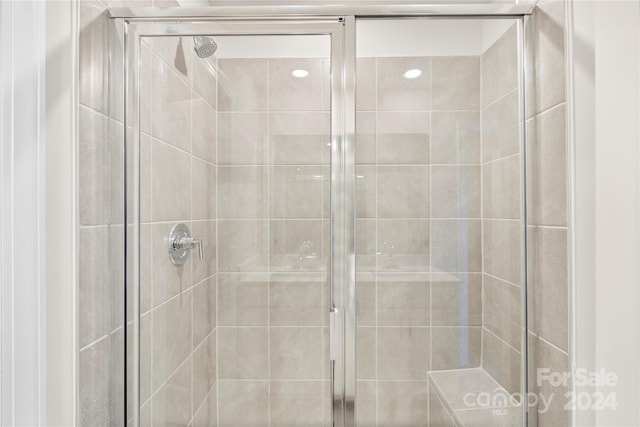 bathroom with a shower with door