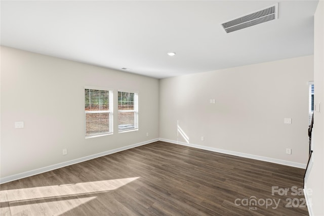 spare room with dark hardwood / wood-style flooring