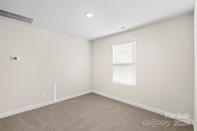 unfurnished room featuring carpet