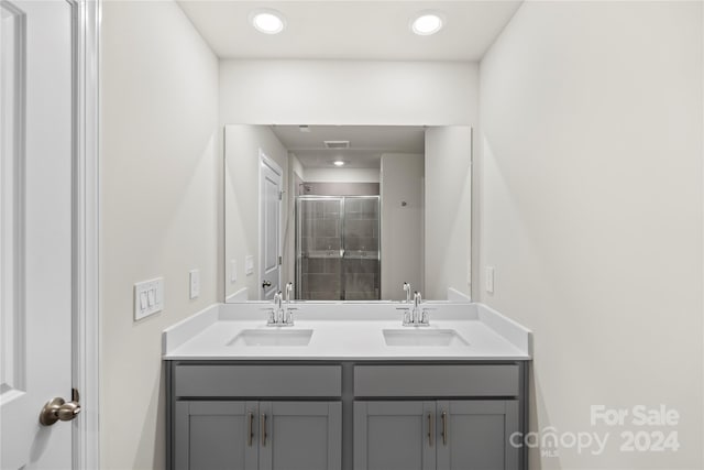 bathroom featuring vanity and an enclosed shower