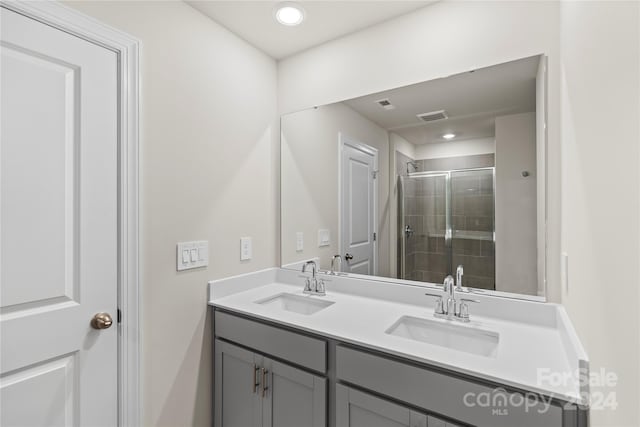 bathroom featuring vanity and an enclosed shower