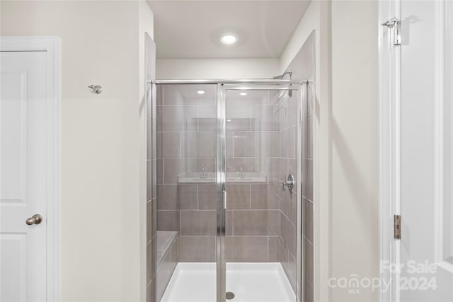 bathroom featuring a shower with door