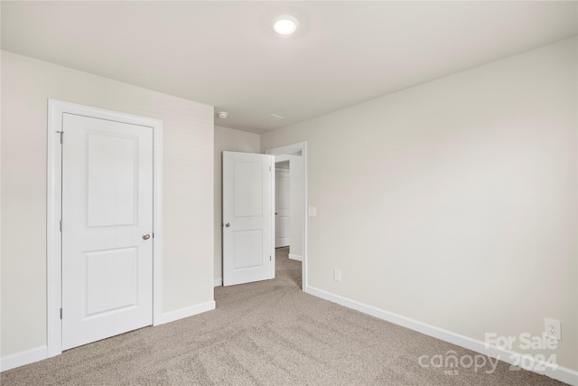 unfurnished bedroom featuring light colored carpet