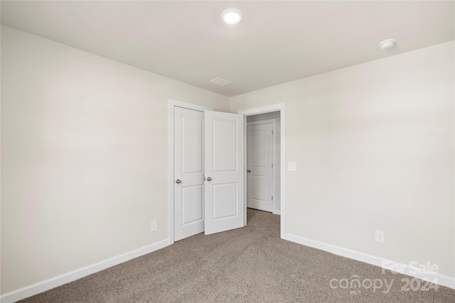 unfurnished bedroom with carpet floors